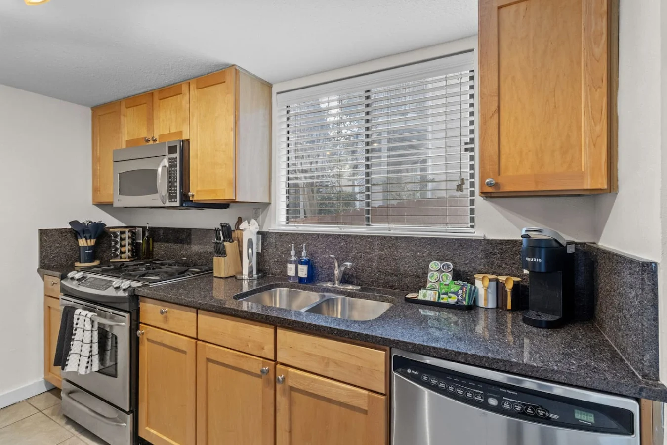 Bright sink area with dishwasher and ample prep space
