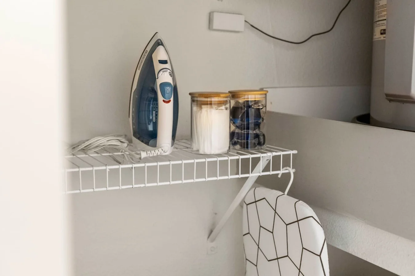 As you step into the laundry room, the modern appliances and ample storage space make it easy to keep things tidy.