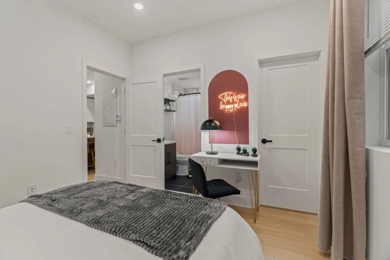Bedroom with direct access to private bathroom and closet area.