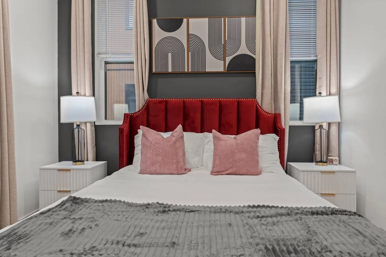 Luxe Bedroom with Queen Bed, Side Tables, and Table Lamps. Plenty of natural sunlight. Windows treated with blinds and blackout curtains for a restful sleep.