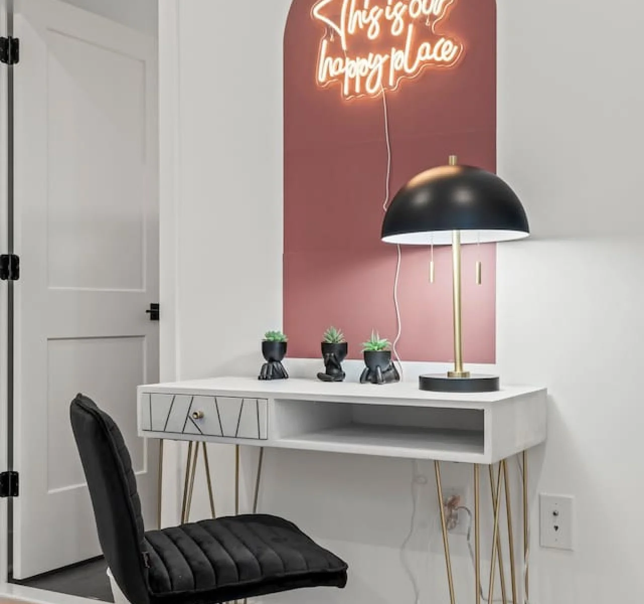 This cozy workspace with warm lighting, and a creative wall display, perfect for productivity.