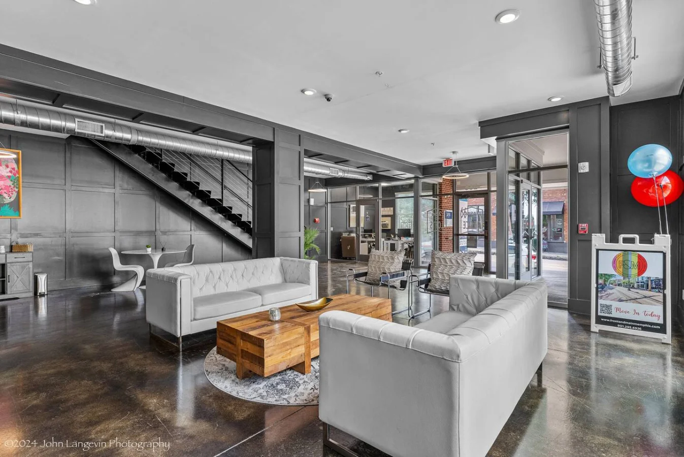 Enjoy a stylish and welcoming living space featuring modern decor and a large flat-screen TV. The unique mirror reflects the vibrant "Good Vibes Only" sign, adding a playful touch to the ambiance. Perfect for relaxation and entertainment.