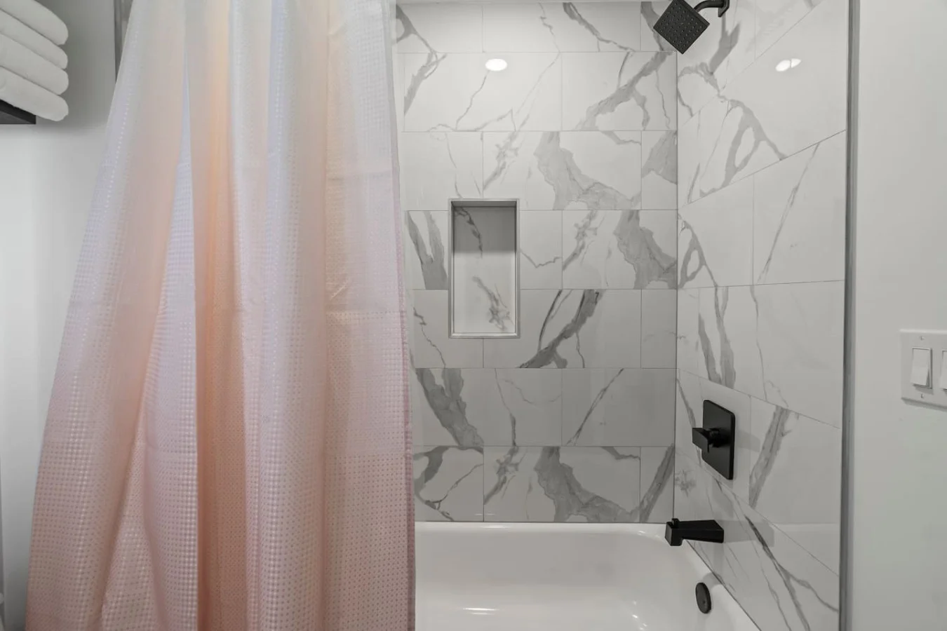 You feel a sense of calm as you enter the bathroom, where the thoughtful design and high-quality materials create a serene environment.