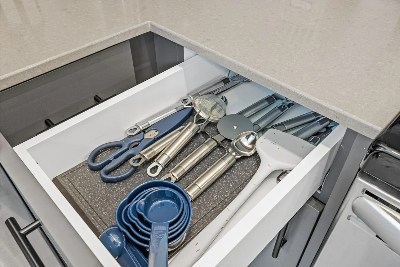 Kitchen utensils with scissors, measuring cups, grater, wine opener, can opener