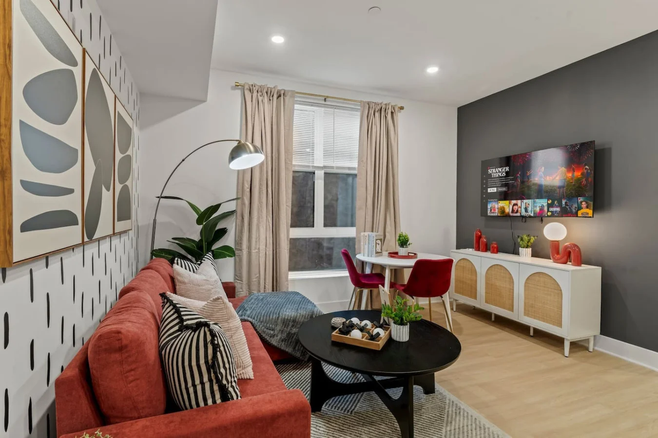 Living Room with Pull Out Sofa Bed, Coffee Table, Dining Table, 55" TV, Overhanging Reading Light