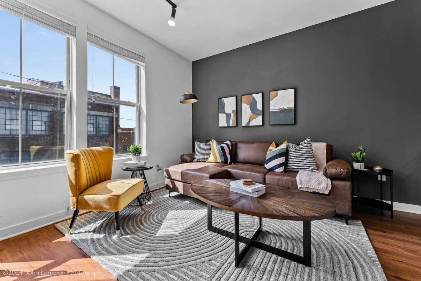 The living room’s cozy vibe makes it the perfect spot to relax, with ample seating and a warm ambiance.