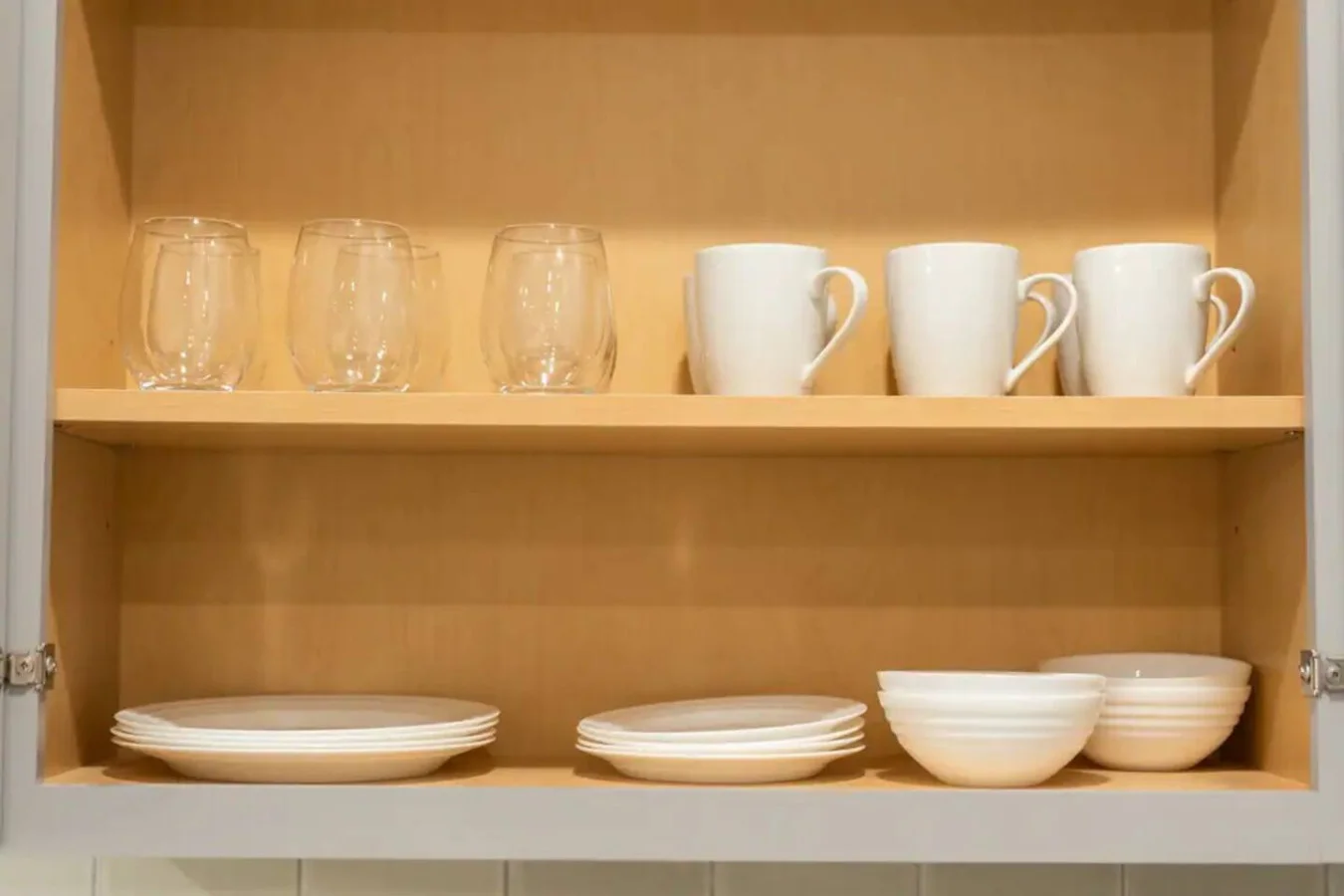 Kitchen cabinets stocked with cooking wares, glassware and silverwares, ideal for mixing up your favorite meals and drinks during your stay.