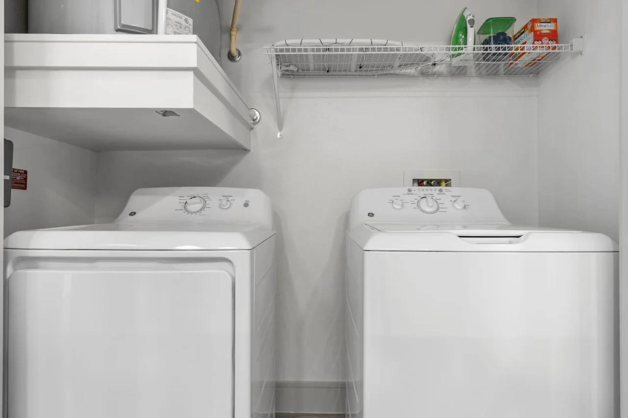 Convenient laundry room with washer, dryer, and all necessary supplies, making it easy to take care of your laundry needs.