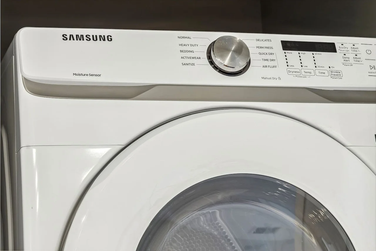 As you step into the laundry room, the modern appliances and ample storage space make it easy to keep things tidy.