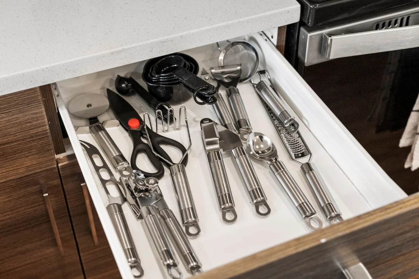 Kitchen utensils with scissors, measuring cups, grater, wine opener, can opener