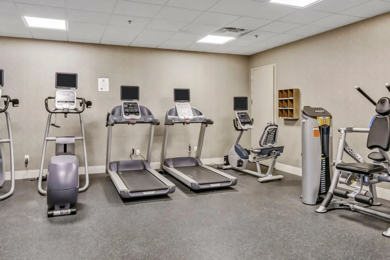 Open floor area with exercise mats, yoga balls, and foam rollers for warm-ups, stretching, or core exercises.