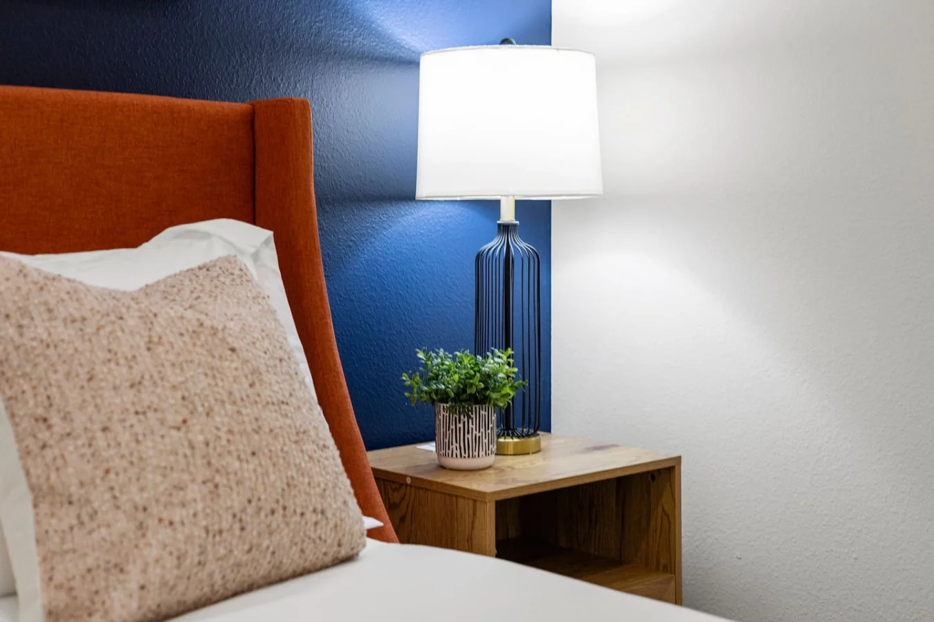 You feel enveloped in comfort as you relax on the queen bed, surrounded by a room designed for tranquility.