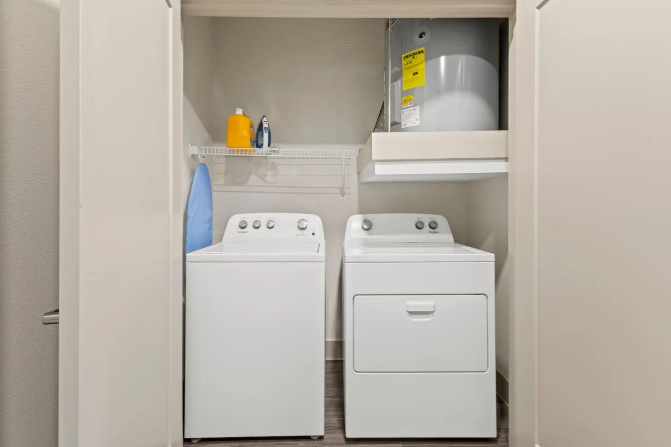 As you step into the laundry room, the modern appliances and ample storage space make it easy to keep things tidy.