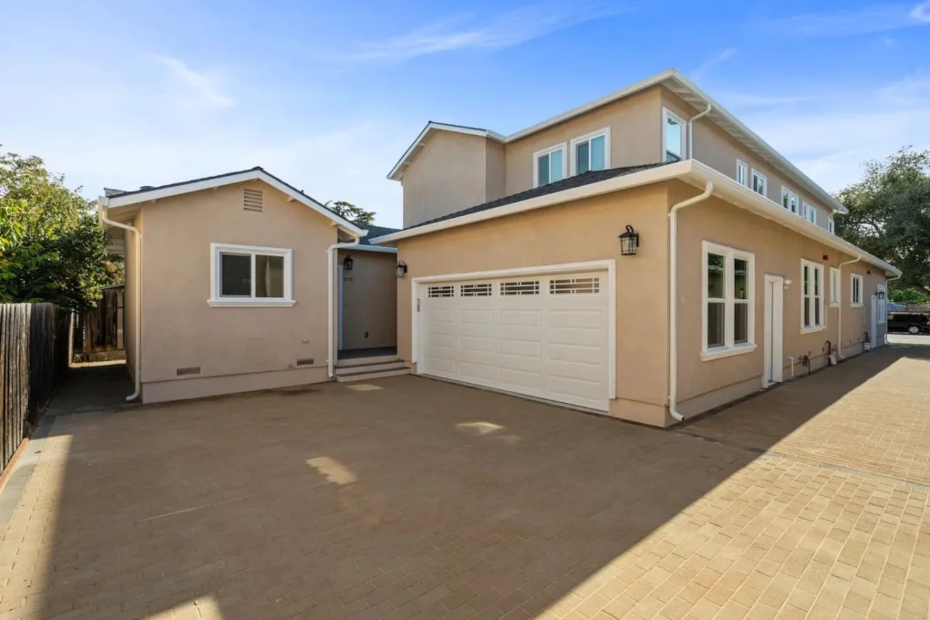 The house’s exterior is a blend of modern and classic design elements, creating a welcoming and stylish facade.