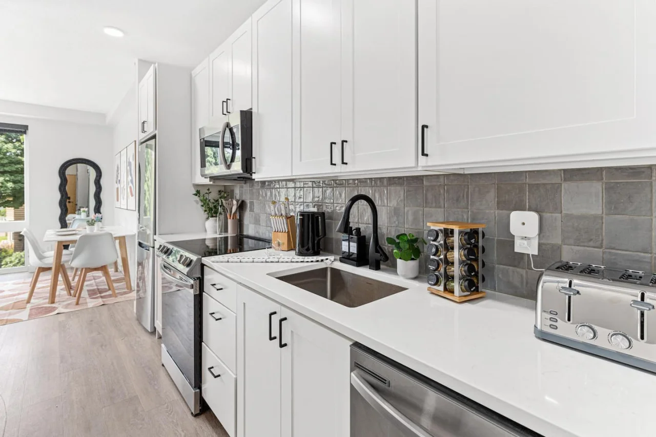 Front hallway - Fully equipped kitchen w/ Stainless steel appliances - Microwave - Dishwasher - Fridge & Freezer - Stove - Sink - Toaster - Spice rack - Kettle - Coffee maker - Knife block. View of dining table.