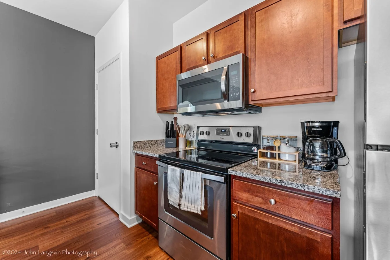Cook with ease in this well-equipped kitchen featuring stainless steel appliances, ample cabinetry, and a stylish backsplash. Whether you're brewing coffee or preparing a gourmet meal, this space is designed for functionality and style, making every meal