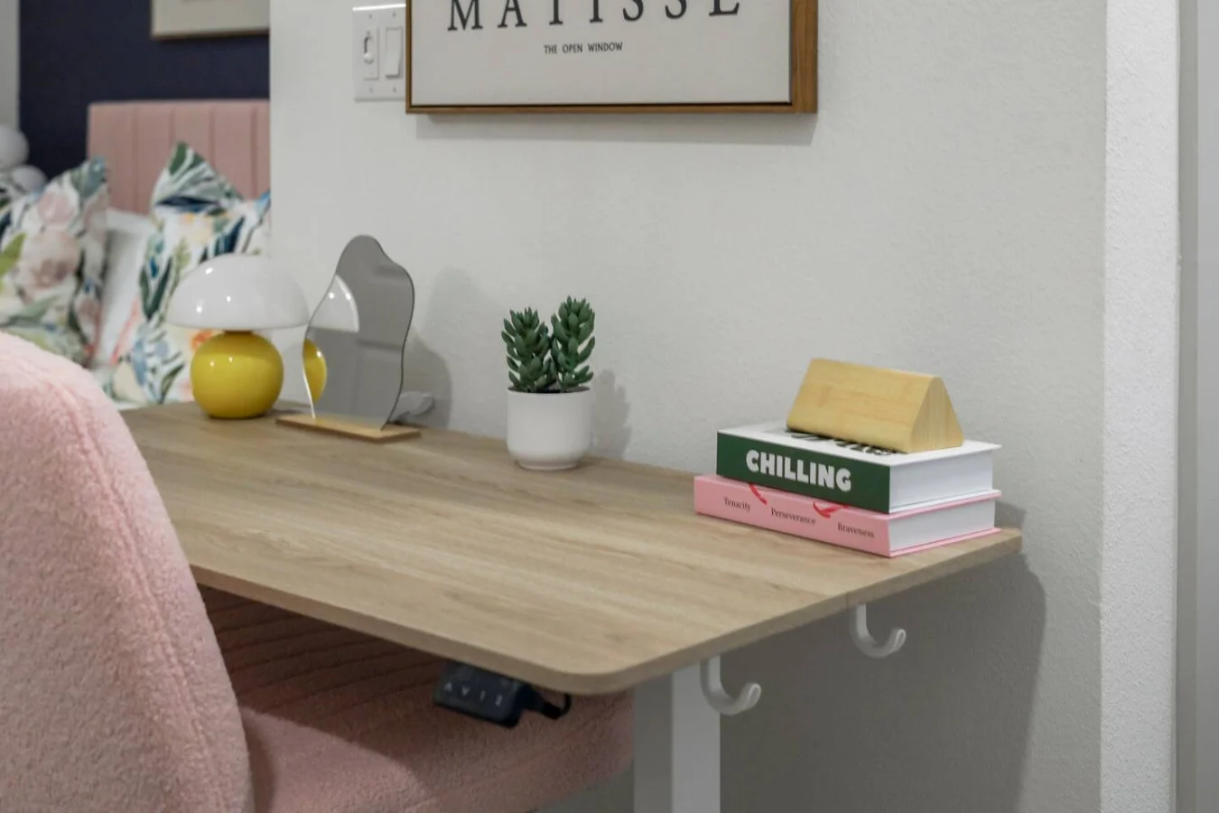 This cozy workspace with warm lighting, and a creative wall display, perfect for productivity.