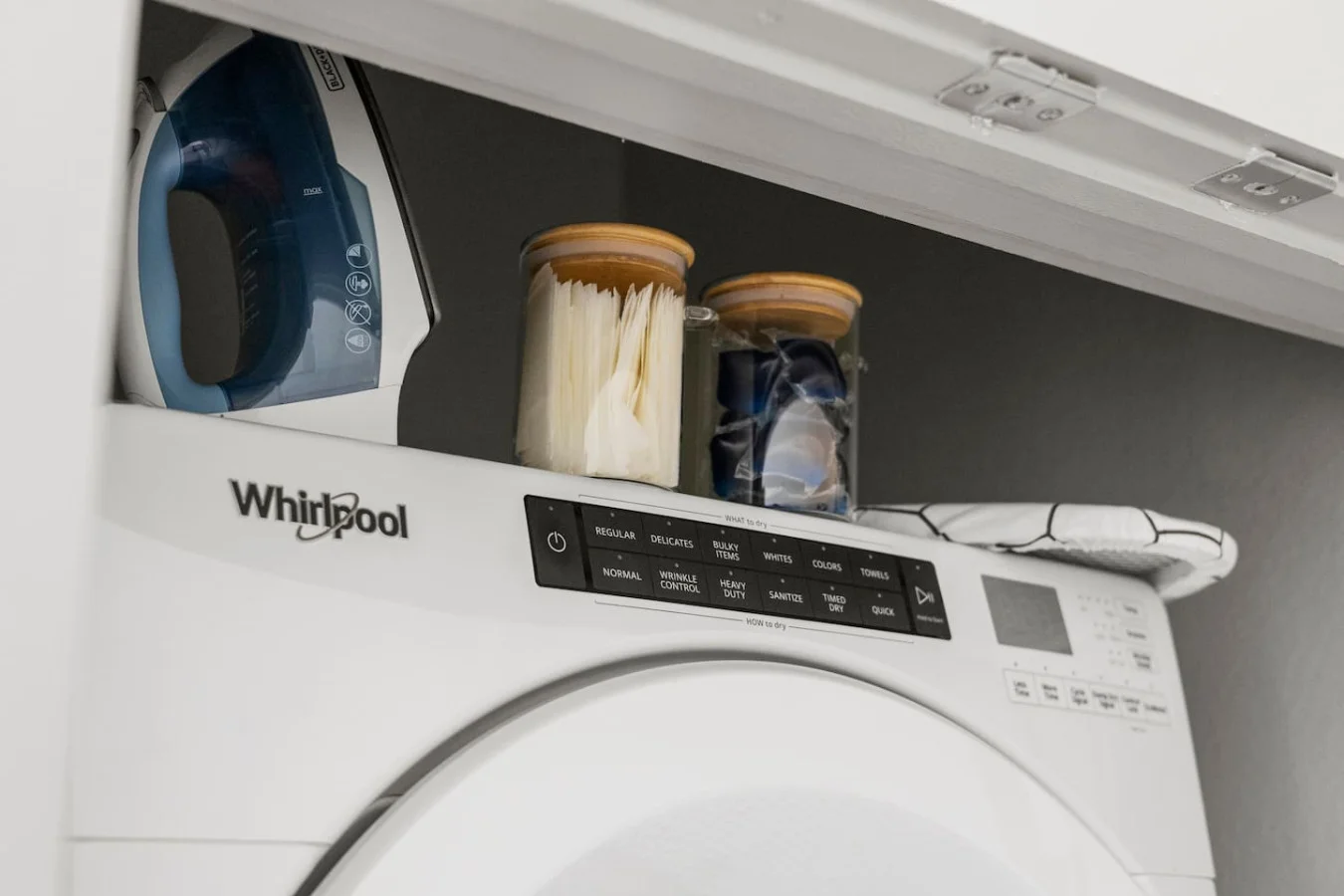 As you step into the laundry room, the modern appliances and ample storage space make it easy to keep things tidy.