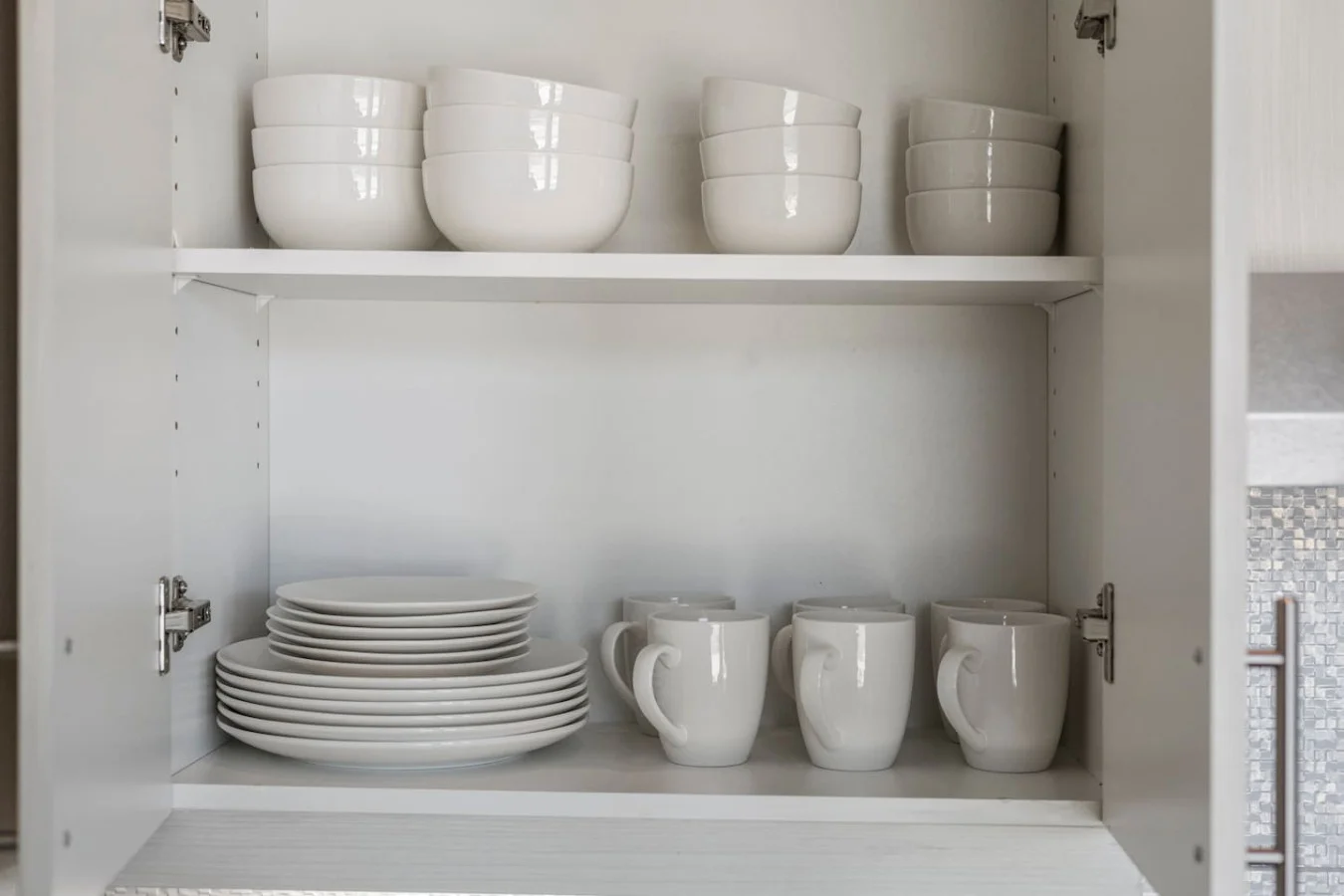 Kitchen cabinets stocked with cooking wares, glassware and silverwares, ideal for mixing up your favorite meals and drinks during your stay.