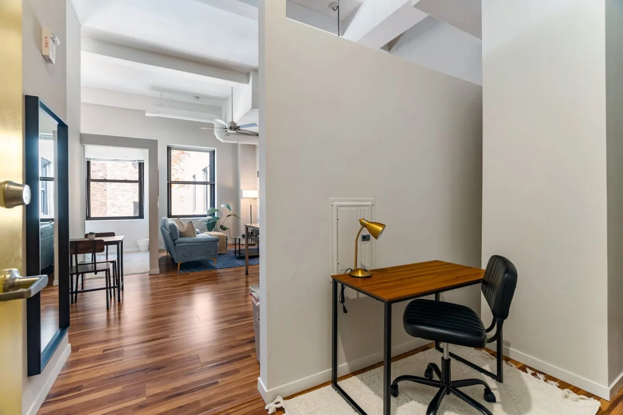 This cozy workspace with warm lighting, and a creative wall display, perfect for productivity.