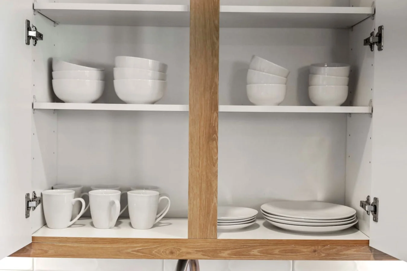 Kitchen cabinets stocked with cooking wares, glassware and silverwares, ideal for mixing up your favorite meals and drinks during your stay.