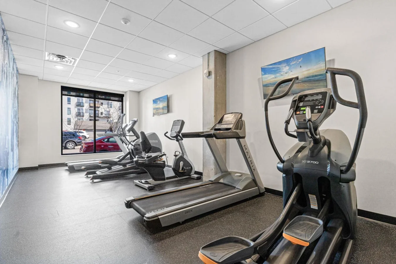 Open floor area with exercise mats, yoga balls, and foam rollers for warm-ups, stretching, or core exercises.