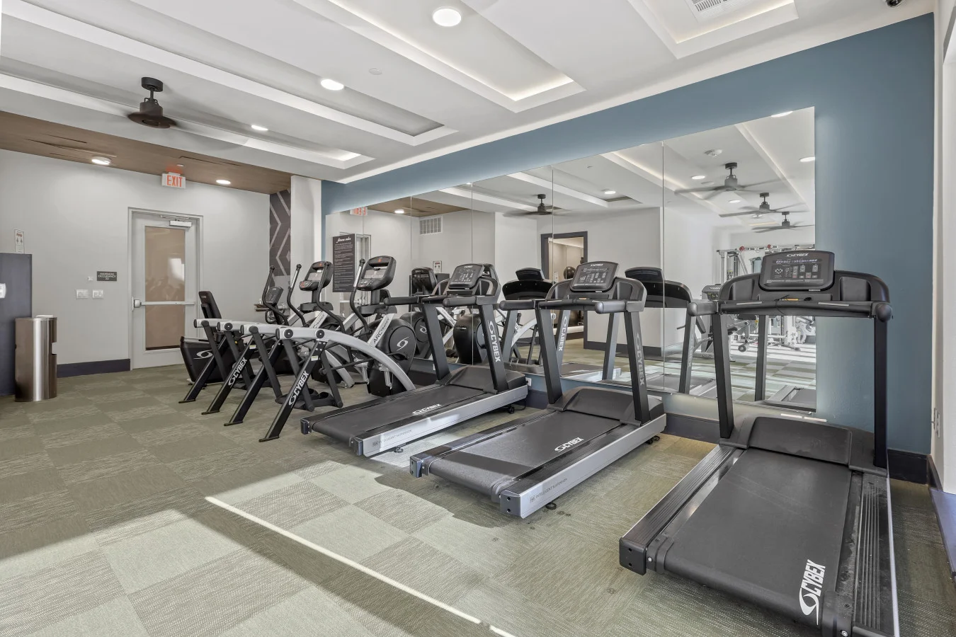 Open floor area with exercise mats, yoga balls, and foam rollers for warm-ups, stretching, or core exercises.