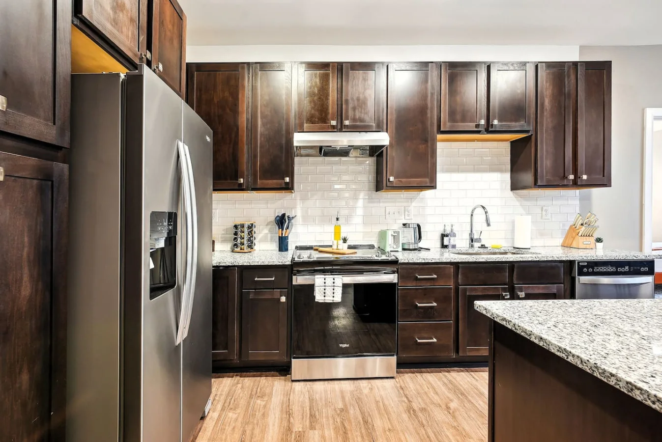 Cook with ease in this well-equipped kitchen featuring stainless steel appliances, ample cabinetry, and a stylish backsplash. Whether you're brewing coffee or preparing a gourmet meal, this space is designed for functionality and style, making every