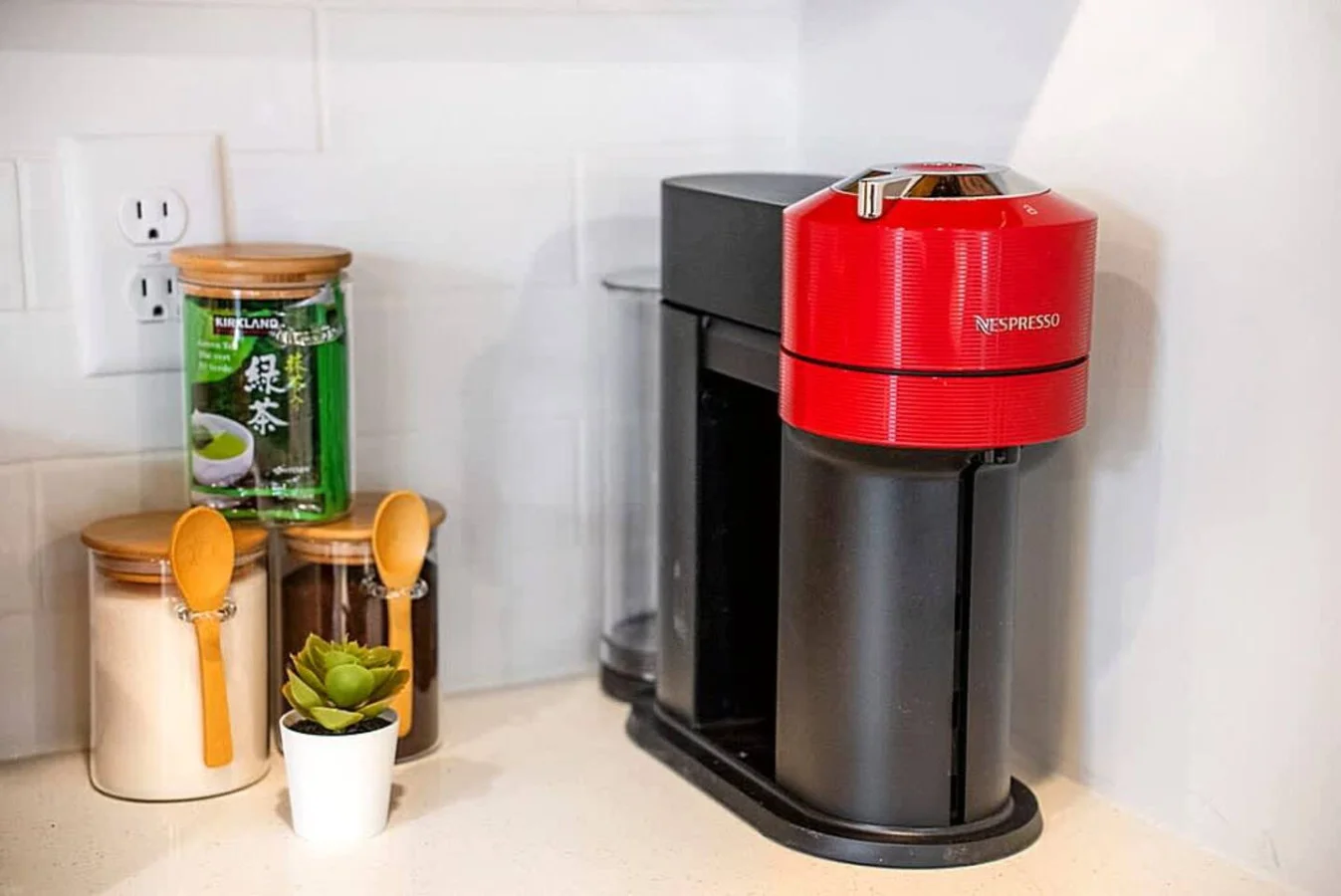 A dedicated coffee station with a modern brewer, utensils, and essentials for easy morning preparation. Guests can start their day with convenience and comfort in this well stocked kitchen area.
