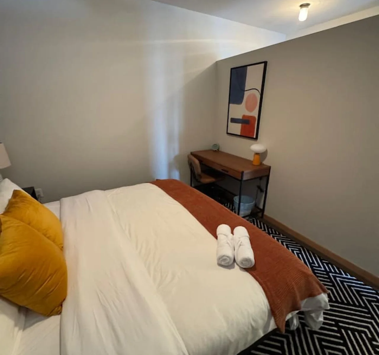 Luxurious queen bedroom featuring a comfortable bed, elegant decor, and plenty of natural light for a rejuvenating sleep.