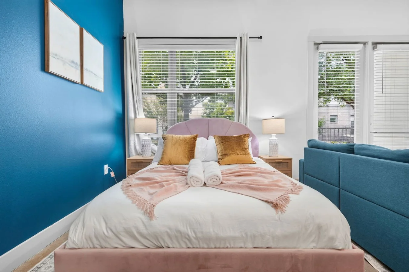 Elegantly dressed pink plush bed thoughtfully prepared with fresh linens and decorative touches.