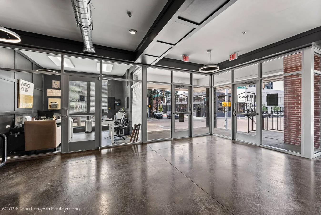 Spacious, well-lit gym equipped with a variety of cardio machines, free weights, and strength-training equipment.