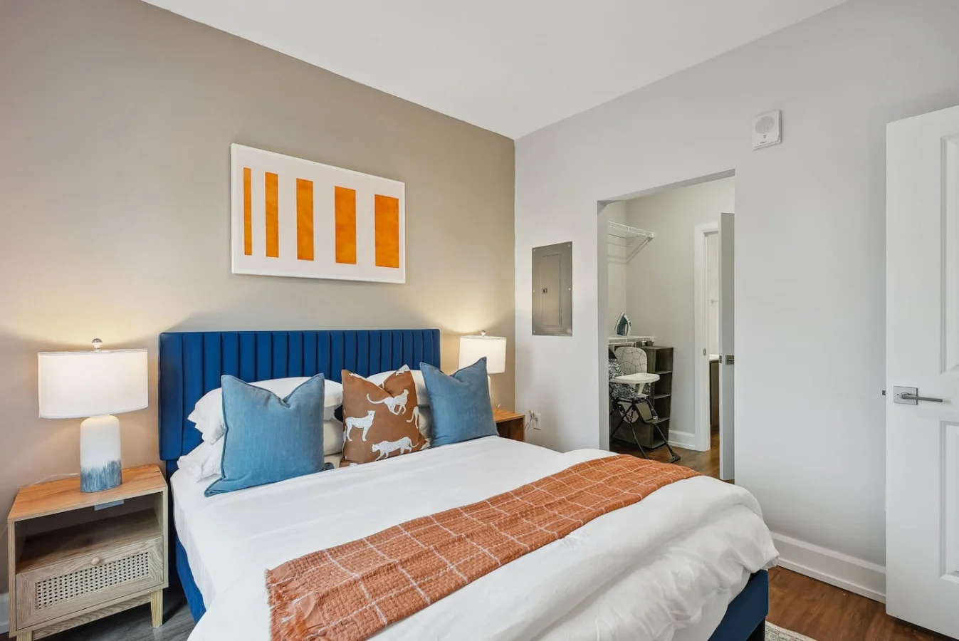 Tranquil bedroom with soft bedding and ample closet space, designed to ensure a restful night's sleep.