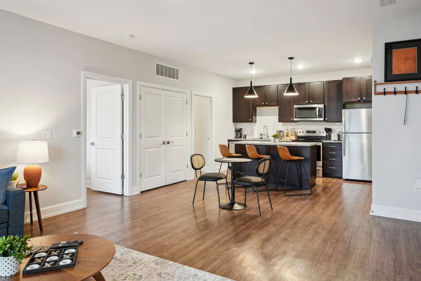 Spacious open-concept living and dining area featuring a vibrant sofa, modern furnishings, and a stylish entertainment setup—ideal for gatherings and relaxation.
