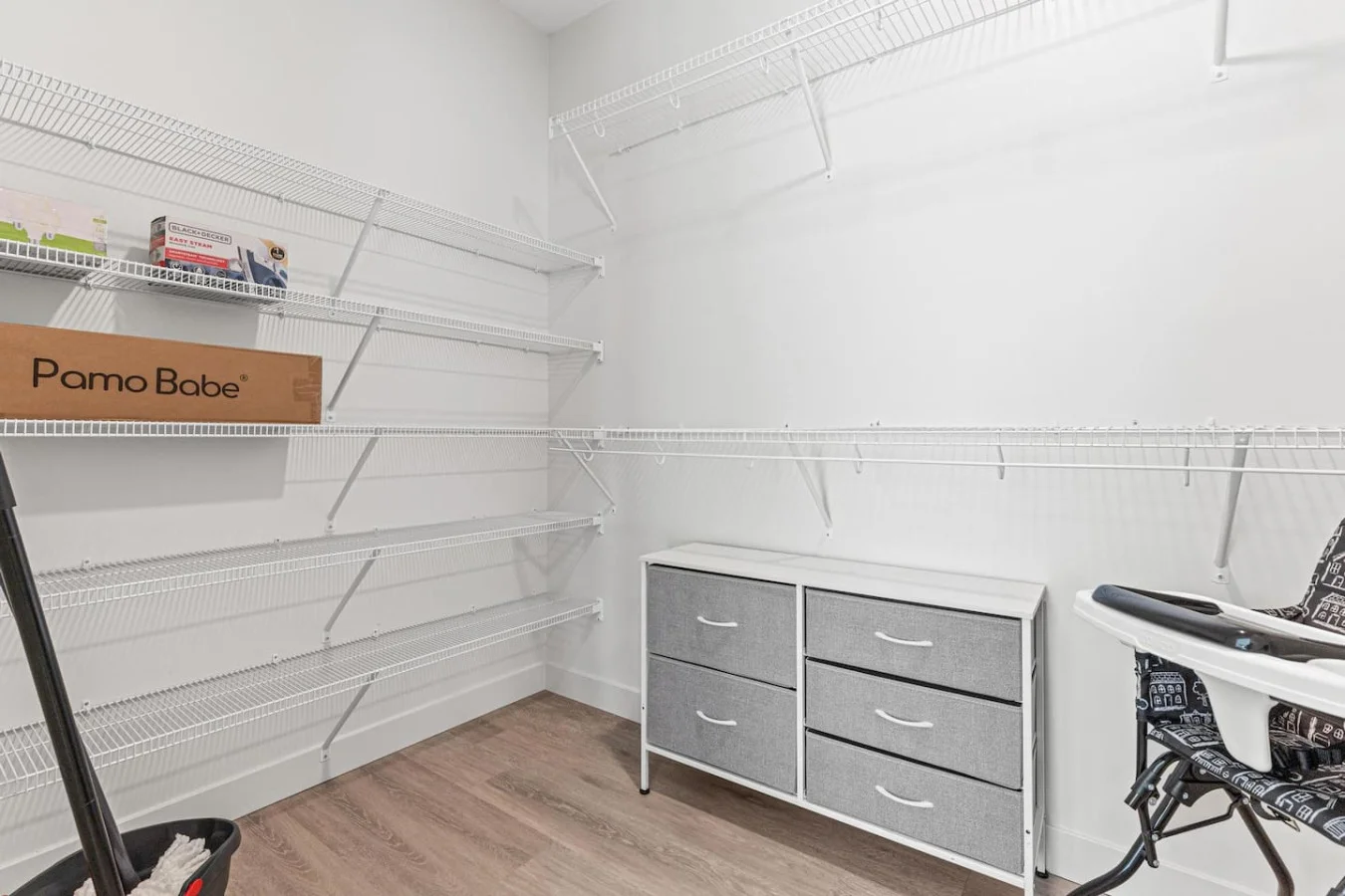 Pack-and-play and high chair neatly stored in the closet—perfect for families traveling with kids.