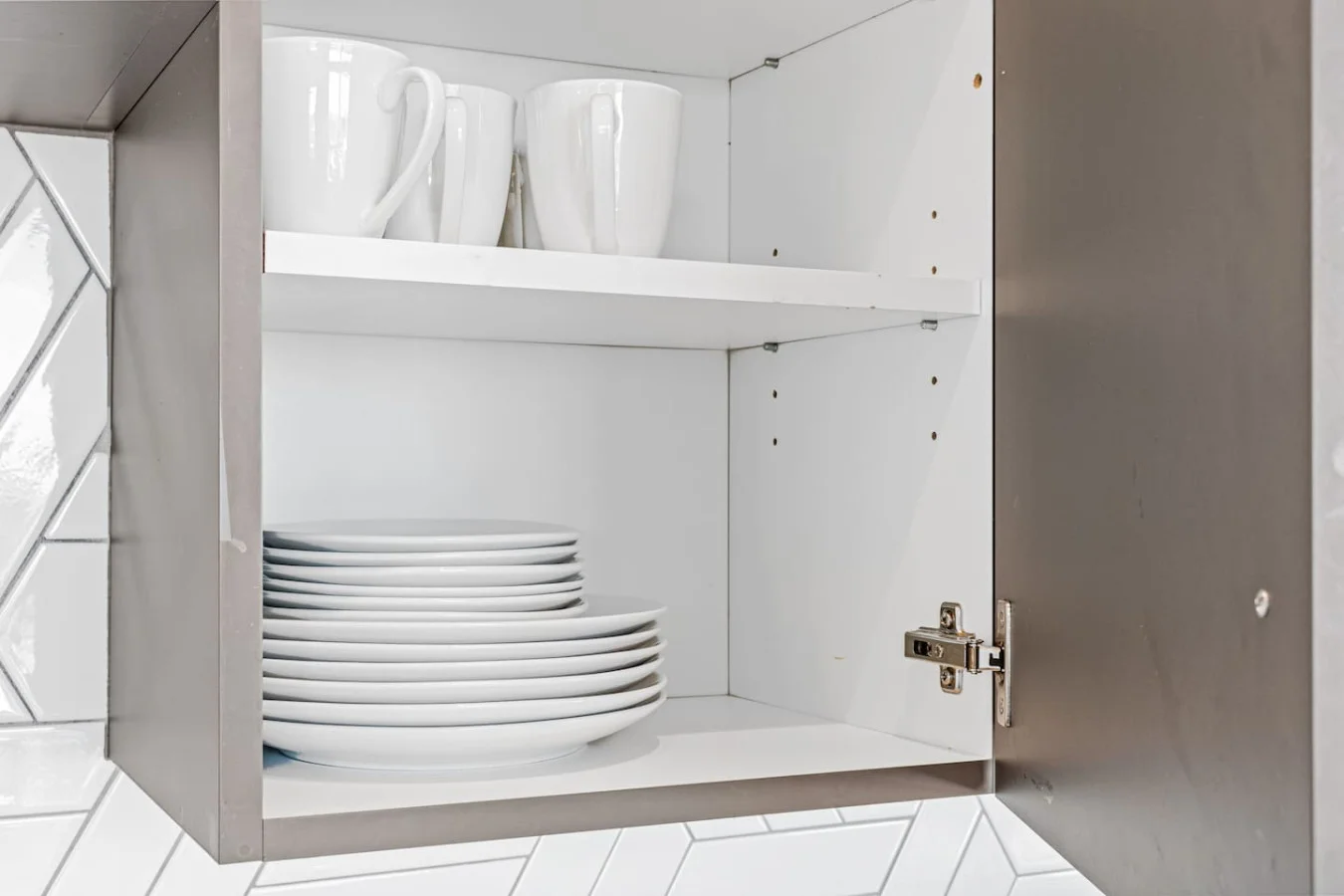 Kitchen cabinets stocked with cooking wares, glassware and silverwares, ideal for mixing up your favorite meals and drinks during your stay.