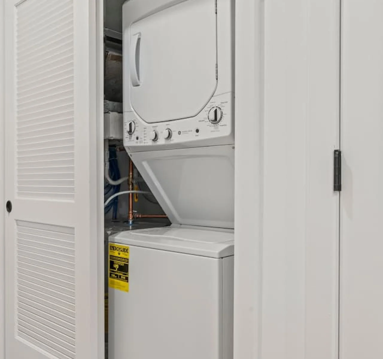 As you step into the laundry room, the modern appliances and ample storage space make it easy to keep things tidy.