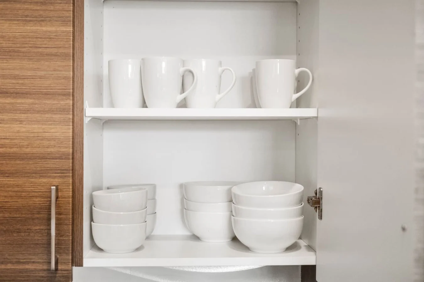 Kitchen cabinets stocked with cooking wares, glassware and silverwares, ideal for mixing up your favorite meals and drinks during your stay.
