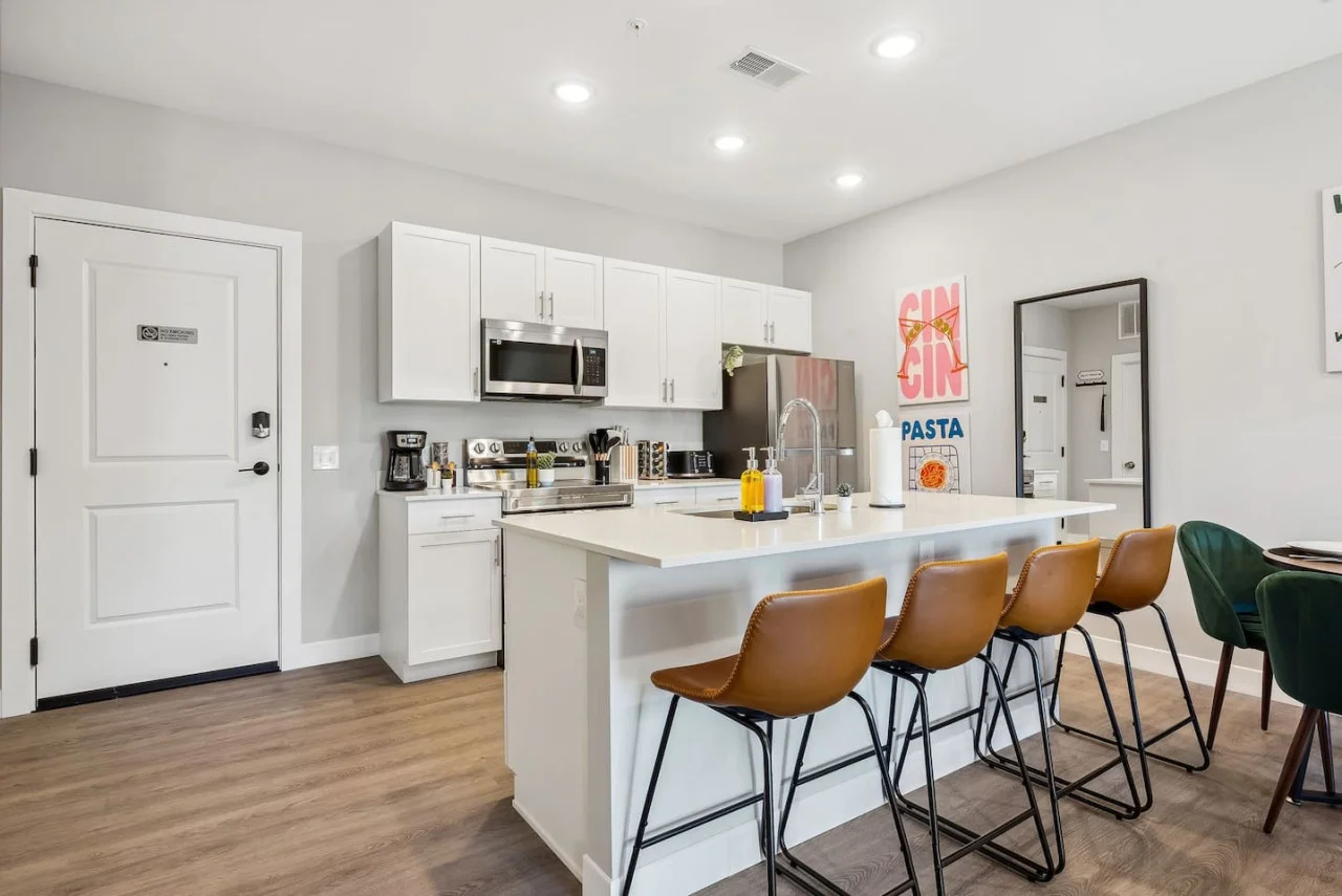 As you approach the home bar, the elegant layout and well-stocked shelves make it the ideal spot to relax.
