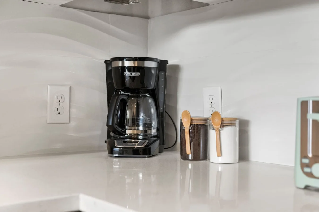 As you open the kitchen, you discover an assortment of coffee pods, and sugar, ensuring you have everything you need for a perfect morning or afternoon pick-me-up.