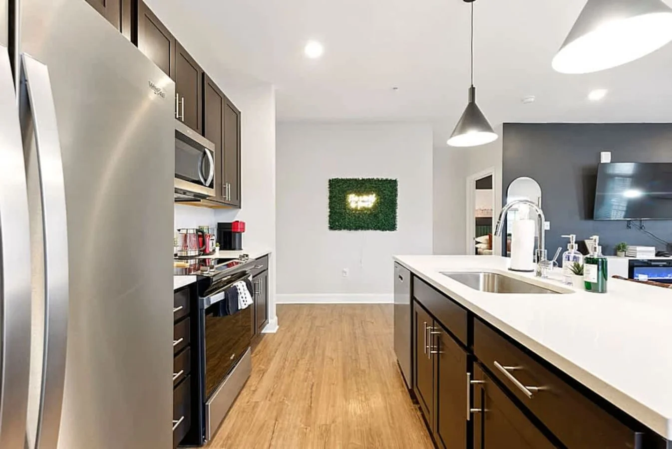 A modern kitchen with stainless steel appliances, sleek cabinetry, and spacious counters. Fully equipped for meal preparation, this space is perfect for cooking, enjoying quick snacks, or gathering around the island.