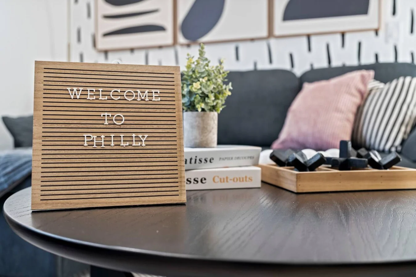Homey vibes with cozy decor, a playful tic-tac-toe game, and a touch of greenery for a relaxing stay.