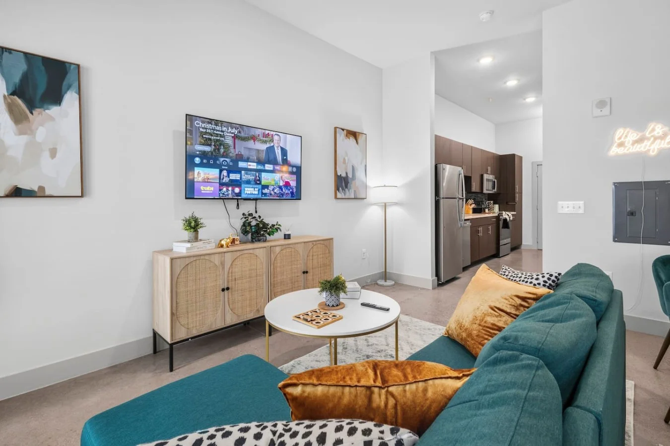 "Seamless flow from the cozy TV lounge right into the modern kitchen area."