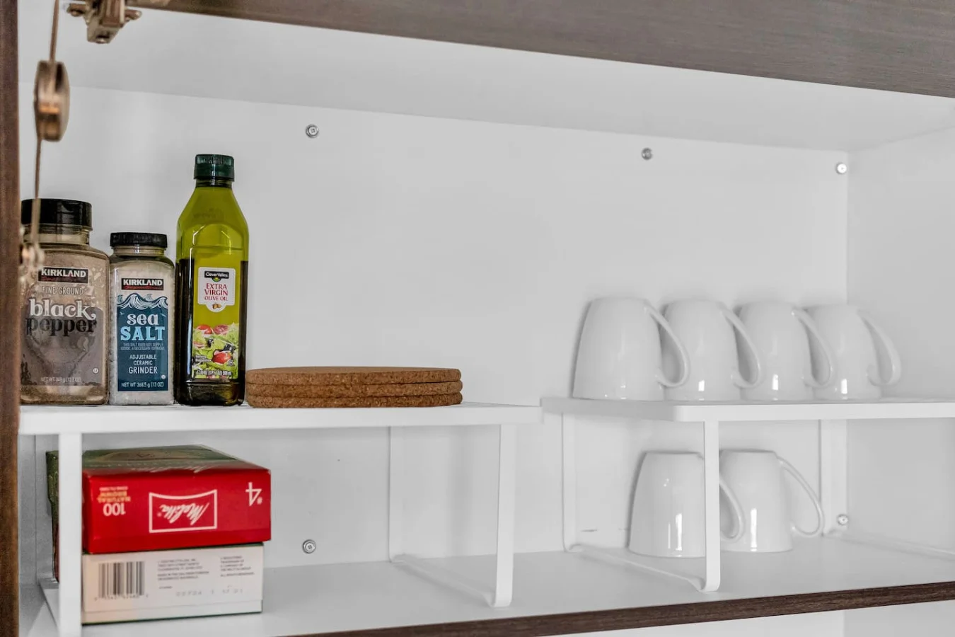 Kitchen cabinets stocked with cooking wares, glassware and silverwares, ideal for mixing up your favorite meals and drinks during your stay.