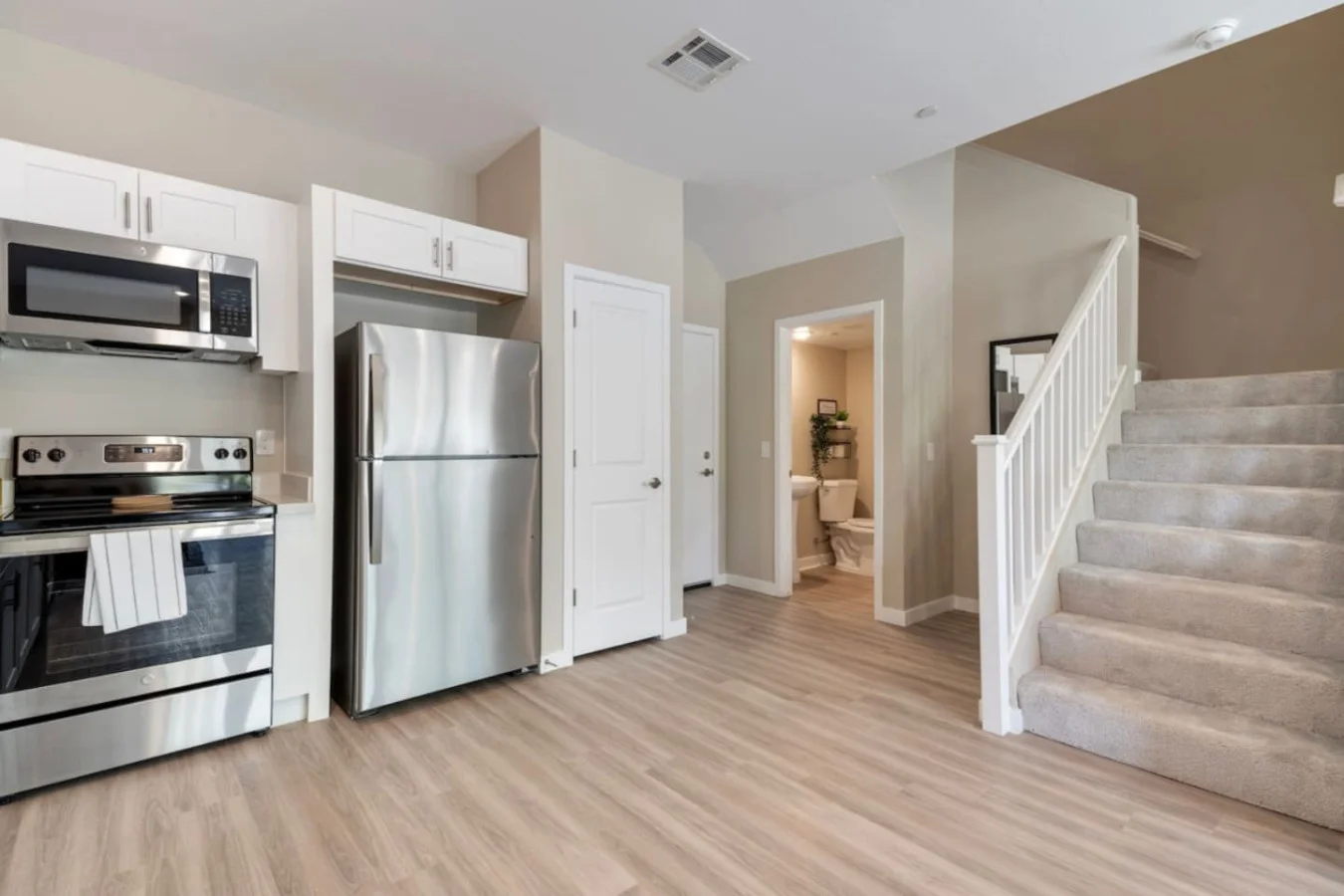 The staircase is a focal point of the home, with its graceful lines and stylish details adding to the overall charm.