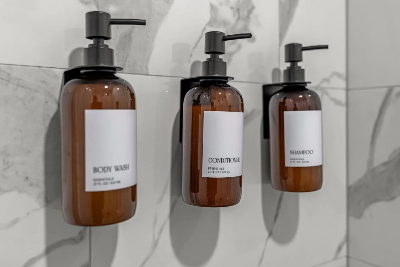 Immaculate bathroom featuring a spacious shower, fresh towels, and complimentary toiletries for a spa-like experience.