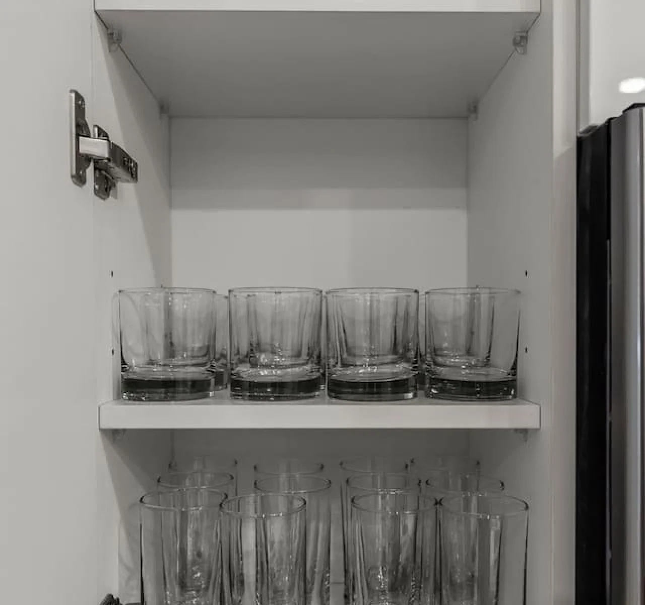 Kitchen cabinets stocked with cooking wares, glassware and silverwares, ideal for mixing up your favorite meals and drinks during your stay.