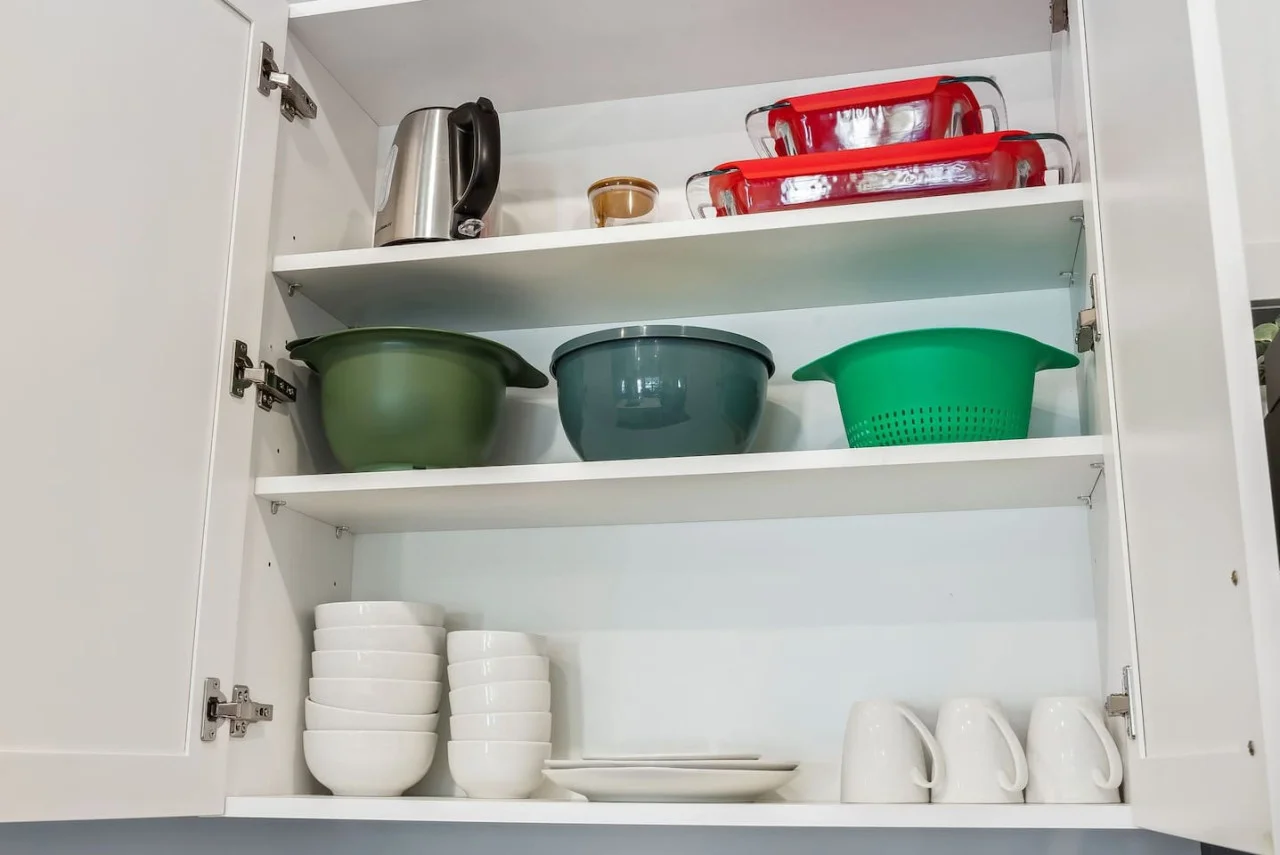 Kitchen cabinets stocked with cooking wares, glassware and silverwares, ideal for mixing up your favorite meals and drinks during your stay.