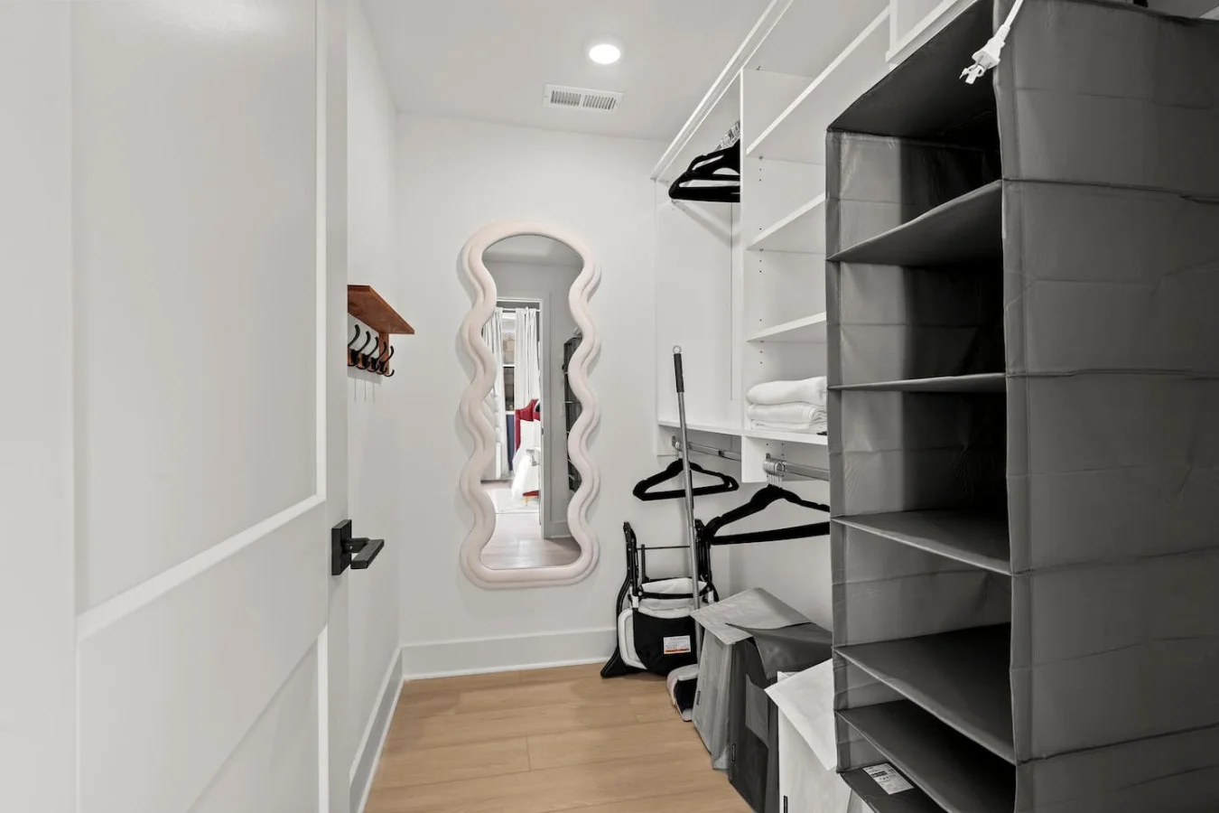 Walk In Closet with Clothing Storage, Hangars, Wall Hooks, Full Length Mirror, and High Chair