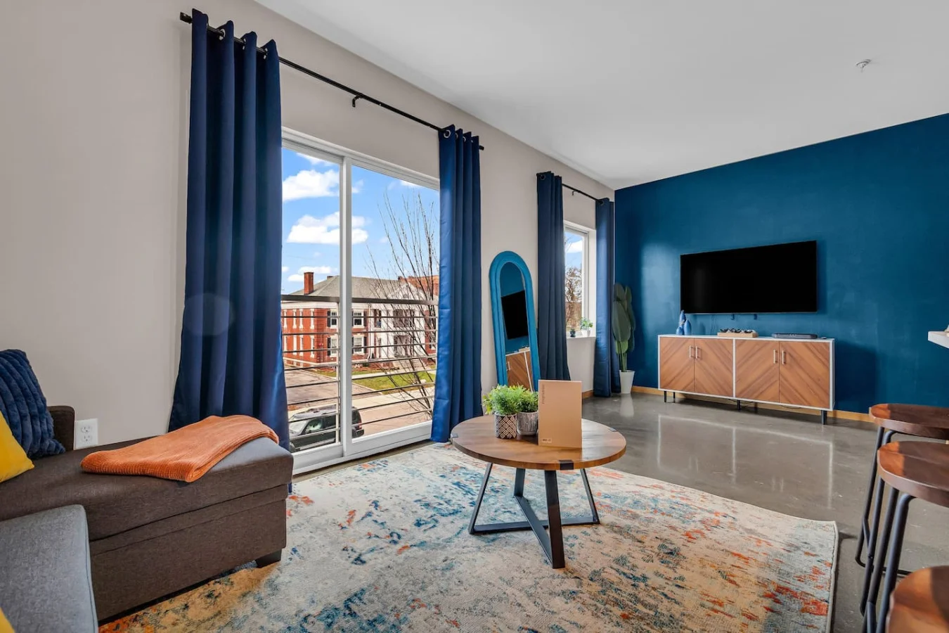 Bright and airy living room with plush seating, a large TV, and tasteful decor, creating the perfect space for relaxation and entertainment.
